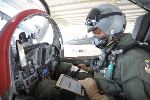 military pilot using ipad in cockpit