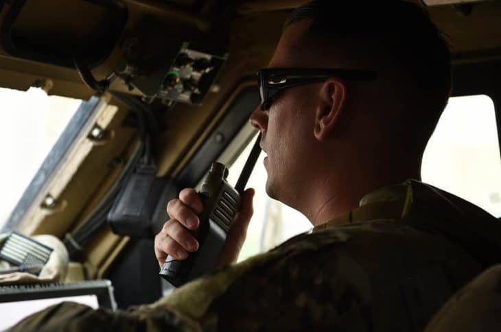 Security Forces Squadron truck commander uses handheld aviation radio